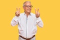 Senior caucasian man wearing business shirt and glasses smiling looking to the camera showing fingers doing victory sign Royalty Free Stock Photo