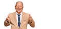 Senior caucasian man wearing business suit and tie success sign doing positive gesture with hand, thumbs up smiling and happy Royalty Free Stock Photo