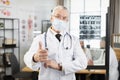 Senior physician in face mask posing with crossed arms Royalty Free Stock Photo