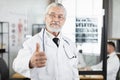 Senior physician in face mask posing with crossed arms Royalty Free Stock Photo