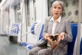 Mature woman amazed by theft from her bag in subway car Royalty Free Stock Photo