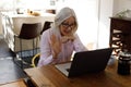 Senior caucasian woman having a video chat on laptop while working from home Royalty Free Stock Photo