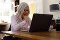 Senior caucasian woman having a video chat on laptop while working from home Royalty Free Stock Photo