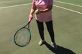 Senior caucasian woman playing tennis on court holding tennis racket Royalty Free Stock Photo