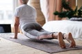 Senior caucasian woman working out, doing urdhva mukha shvanasana or upward facing dog pose