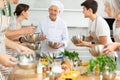 Senior chef sharing professional secrets of cooking at group class Royalty Free Stock Photo