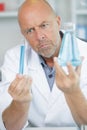 senior chemist holds flasks in hands Royalty Free Stock Photo