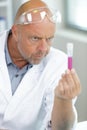 senior chemist in protective eyeglasses holding beaker Royalty Free Stock Photo