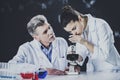 Senior chemistry professor and his assistant working in laboratory Royalty Free Stock Photo