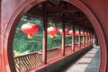 Senior chinese woman walking in a traditional corridor