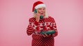 Senior Christmas grandmother woman talking on wired vintage 80s telephone, say hey you call me back