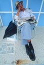 A senior citizen asleep in a lawn chair,