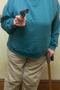 Senior Citizen Holding A Gun Royalty Free Stock Photo