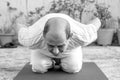 Senior Citizen or an Old Indian Man Performing Yoga Early Morning, in his Terrace in white Tshirt and Pants. Stay Home Stay Safe a Royalty Free Stock Photo