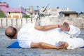 Senior Citizen or an Old Indian Man Performing Yoga Early Morning, in his Terrace in white Tshirt and Pants. Stay Home Stay Safe a Royalty Free Stock Photo