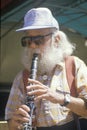 A senior citizen playing the clarinet
