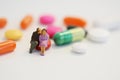 Senior citizens resting on colorful pills, social care concept