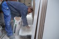 Senior constructor worker preparing tile adhesive mortar.