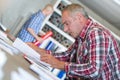 Senior contractor at desk doing paperwork