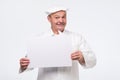 Senior cook man holding sign speech bubble smiling delighted Royalty Free Stock Photo