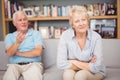 Senior couple arguing while sitting on sofa Royalty Free Stock Photo