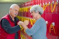 senior couple attaching locker key to wrist Royalty Free Stock Photo