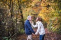 Senior couple in an autumn nature, holding hands and having fun. Royalty Free Stock Photo