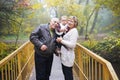 Senior couple with baby in the autumn park, grandparents with little girl