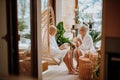 Senior couple in bathrobes enjoying time together in their living room, drinking hot tea, calm and hygge atmosphere. Royalty Free Stock Photo