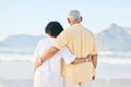 Senior couple at beach, hug and travel, retirement and love outdoor, vacation with ocean view and relax in nature. Peace Royalty Free Stock Photo