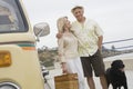 Senior Couple On Beach Promenade With Campervan