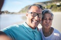 Senior couple, beach selfie and portrait with smile, pouting lips and happy for vacation, summer and memory. Mature man Royalty Free Stock Photo