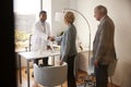 Senior Couple Being Greeted By Male Doctor With Handshake On Visit To Hospital For Consultation Royalty Free Stock Photo