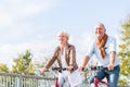 Senior couple with bicycles on bridge Royalty Free Stock Photo