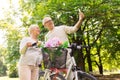 Senior couple with bicycles taking selfie at park Royalty Free Stock Photo