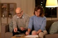 Senior couple with bills counting money at home Royalty Free Stock Photo