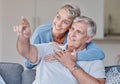 Senior couple, bonding or hand pointing on sofa in Australia house or home living room in future planning or life Royalty Free Stock Photo