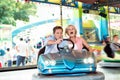 Senior couple in the bumper car at the fun fair Royalty Free Stock Photo