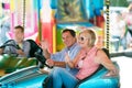 Senior couple in the bumper car at the fun fair Royalty Free Stock Photo