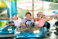 Senior couple in the bumper car at the fun fair Royalty Free Stock Photo