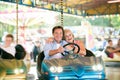 Senior couple in the bumper car at the fun fair Royalty Free Stock Photo