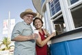 Senior Couple Buying Drinks At Food Stand Royalty Free Stock Photo