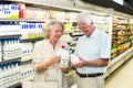 Senior couple buying milk Royalty Free Stock Photo