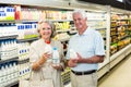 Senior couple buying milk Royalty Free Stock Photo