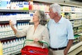 Senior couple buying milk Royalty Free Stock Photo