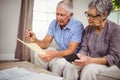 Senior couple calculating bills in living room Royalty Free Stock Photo