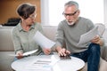 Senior couple calculating utility bills, paying the loan or checking domestic finances Royalty Free Stock Photo