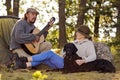 Senior couple camping and enjoying music Royalty Free Stock Photo