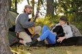 Senior couple camping and enjoying music Royalty Free Stock Photo