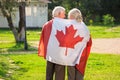 Senior couple and Canadian flag. Royalty Free Stock Photo